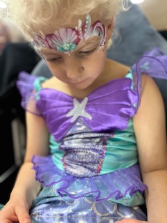 Girl with mermaid face painting in Stafford